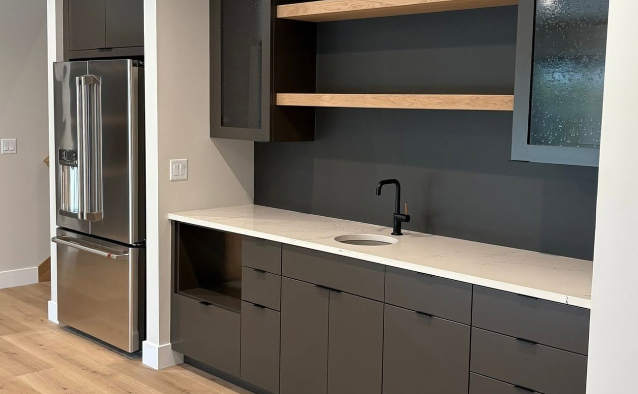 kitchen with black cabinets and white countertops